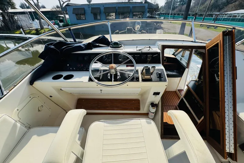 Slide: The Image of 1987 Bayliner 4550 Motoryacht helm with steering wheel and control panel. - 29