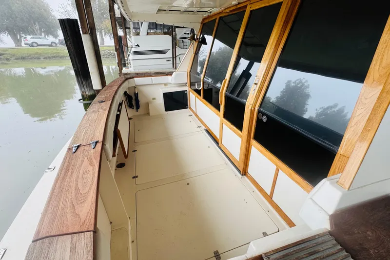 Slide: The Image of 1987 Bayliner 4550 Motoryacht deck with wooden trim and glass doors. - 31