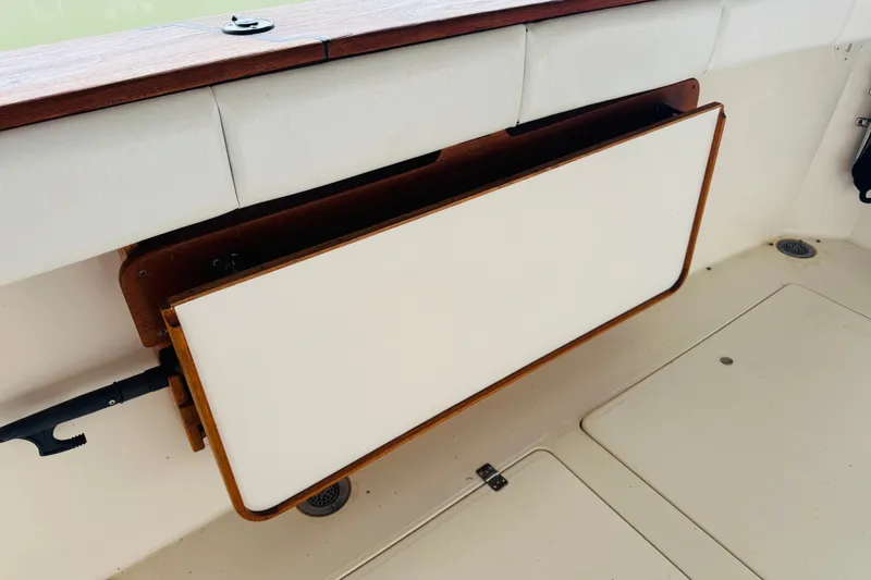 Slide: The Image of Foldable table on 1987 Bayliner 4550 Motoryacht, featuring wood trim and white surface. - 32