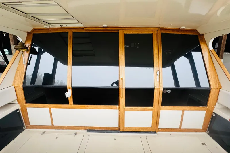 Slide: The Image of 1987 Bayliner 4550 Motoryacht with wooden-framed glass doors and sleek design. - 34
