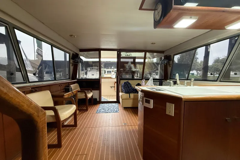 Slide: The Image of Interior of 1987 Bayliner 4550 Motoryacht with wood flooring and seating area. - 38