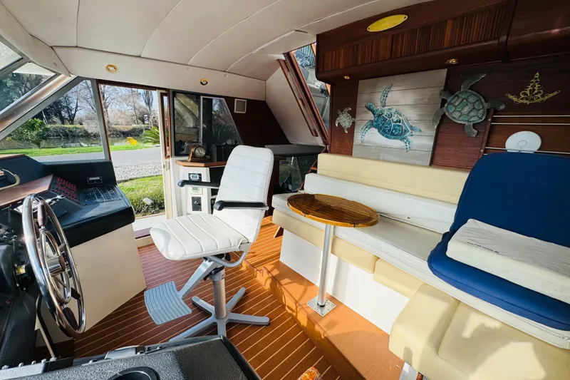 Slide: The Image of 1987 Bayliner 4550 Motoryacht interior with helm, seating, and turtle decor. - 57