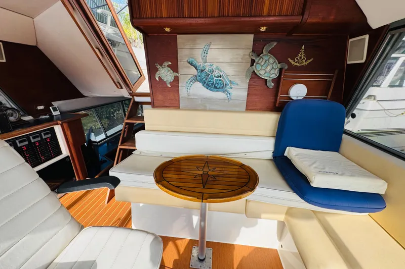 Slide: The Image of Interior of 1987 Bayliner 4550 Motoryacht with turtle artwork and seating area. - 58