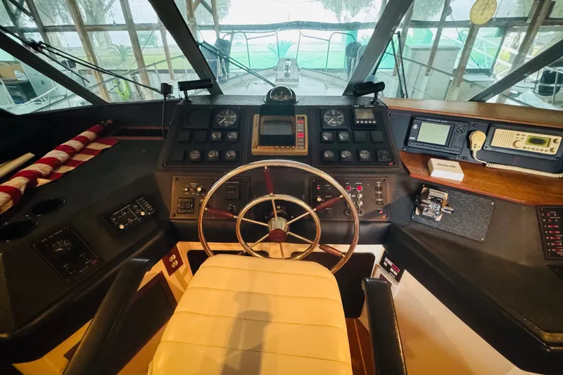 Slide: The Image of Cockpit of 1987 Bayliner 4550 Motoryacht with steering wheel and navigation instruments. - 59
