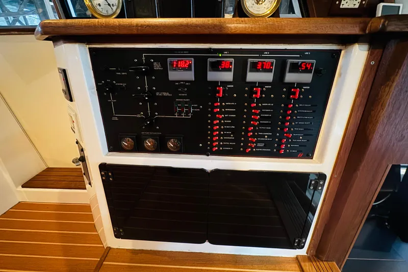 Slide: The Image of Electrical control panel on a 1987 Bayliner 4550 Motoryacht, featuring gauges and switches. - 63