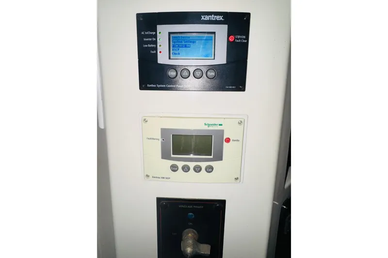 Slide: The Image of Control panels on a 1987 Bayliner 4550 Motoryacht, featuring Xantrex and Schneider Electric systems. - 67