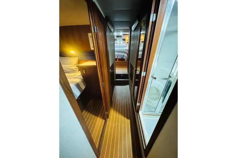 Slide: The Image of Interior hallway of 1987 Bayliner 4550 Motoryacht with wood paneling and cozy lighting. - 69