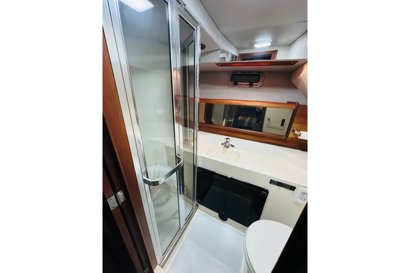Slide: The Image of 1987 Bayliner 4550 Motoryacht bathroom with shower, sink, and mirror. - 72