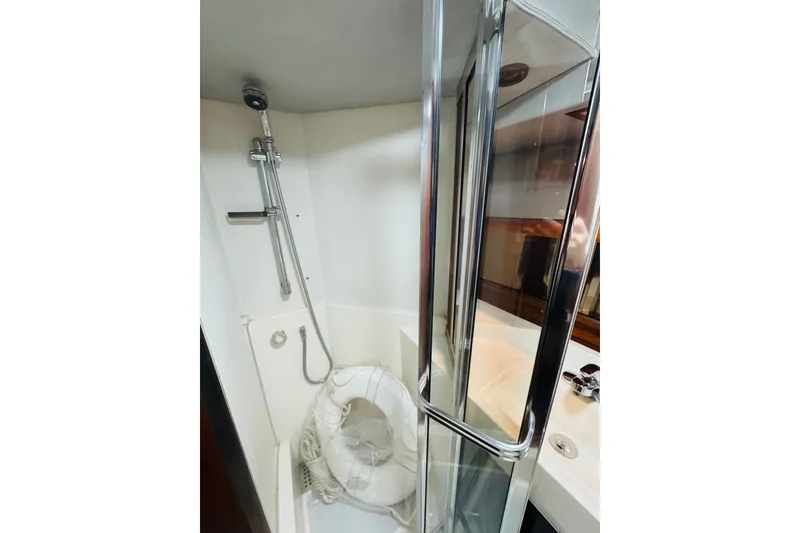 Slide: The Image of Shower area in 1987 Bayliner 4550 Motoryacht with chrome fixtures and glass door. - 74