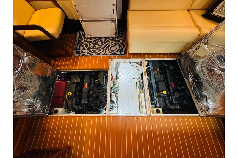 Slide: The Image of Engine compartment of 1987 Bayliner 4550 Motoryacht with open hatches, revealing dual engines. - 83