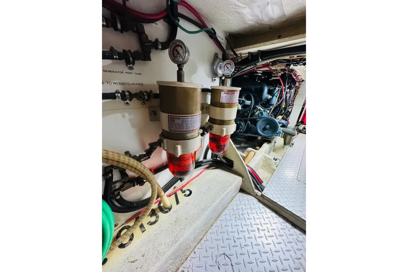 Slide: The Image of Engine room of 1987 Bayliner 4550 Motoryacht with fuel filters and gauges. - 86