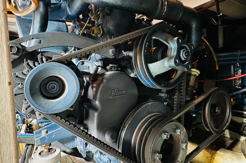 Slide: The Image of Engine components of a 1987 Bayliner 4550 Motoryacht, showcasing belts and pulleys. - 88