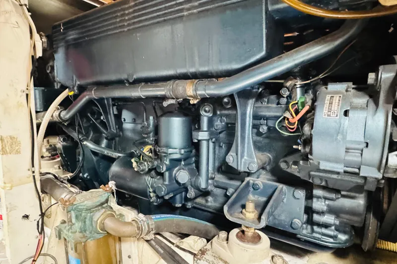 Slide: The Image of Engine compartment of a 1987 Bayliner 4550 Motoryacht, showcasing mechanical components and wiring. - 89