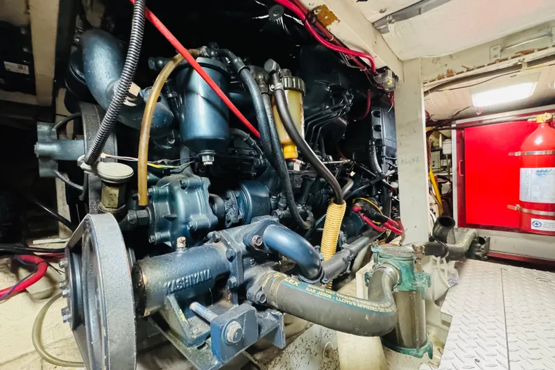 Slide: The Image of Engine room of 1987 Bayliner 4550 Motoryacht, showcasing detailed mechanical components. - 92