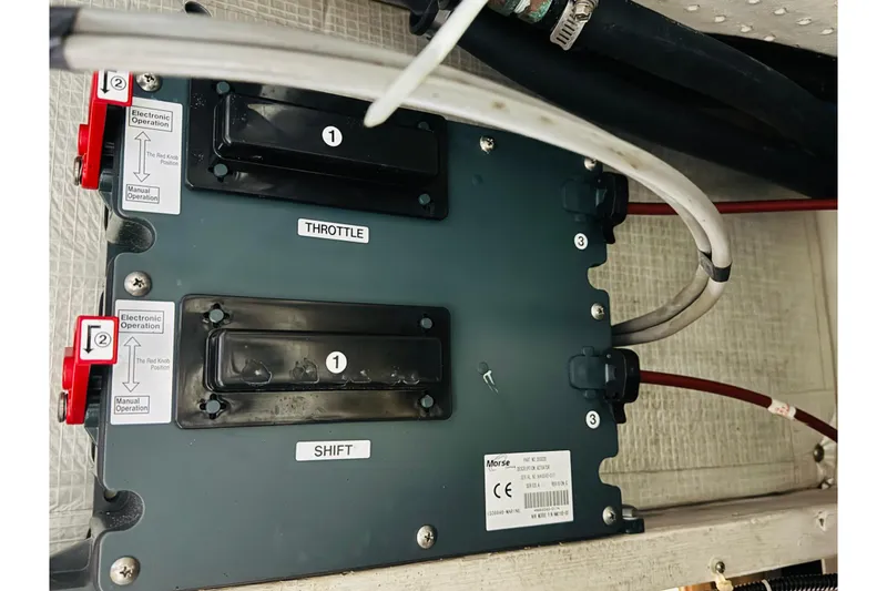 Slide: The Image of Control panel of a 1987 Bayliner 4550 Motoryacht, featuring throttle and shift mechanisms. - 94