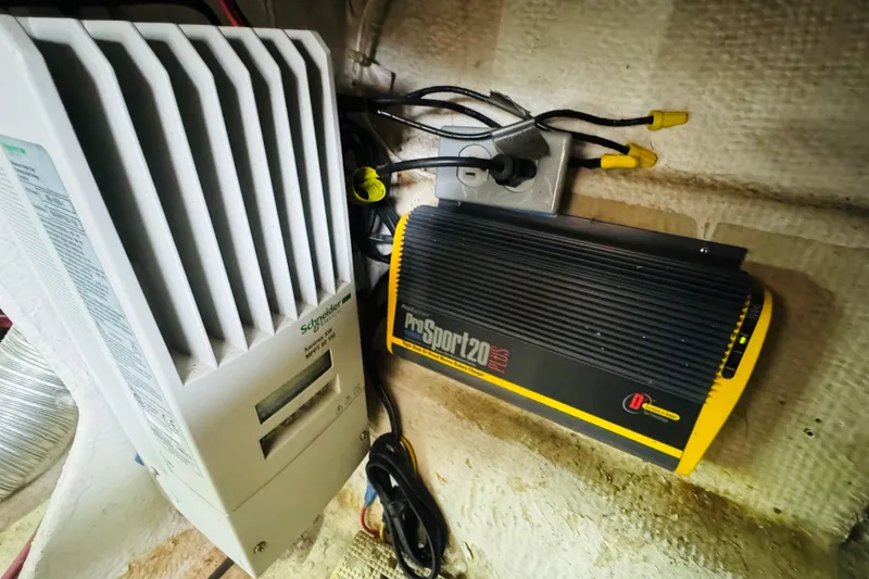 Slide: The Image of Electrical components inside a 1987 Bayliner 4550 Motoryacht, featuring a ProSport20 charger. - 95