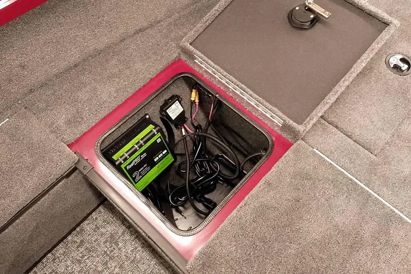 Slide: The Image of 2026 Ranger Aluminum VS1665 SC boat battery compartment with charger and wiring. - 14