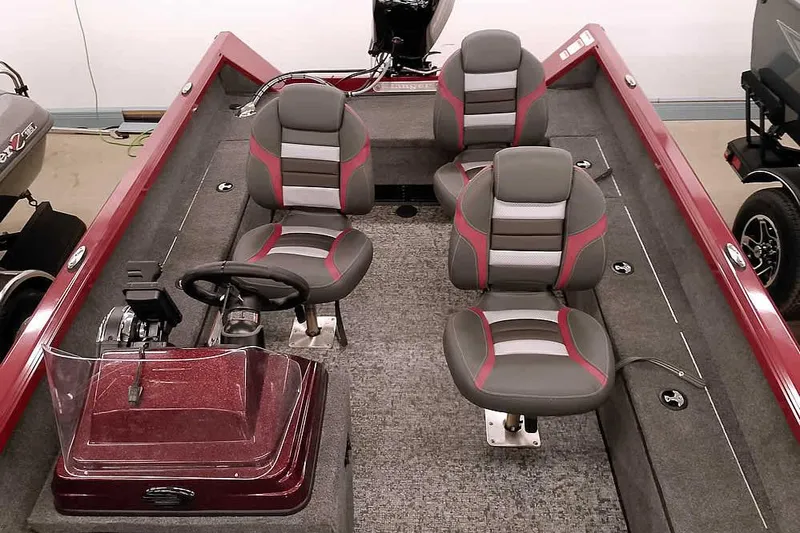 Slide: The Image of 2026 Ranger Aluminum VS1665 SC boat interior with gray and red seating, steering console. - 17