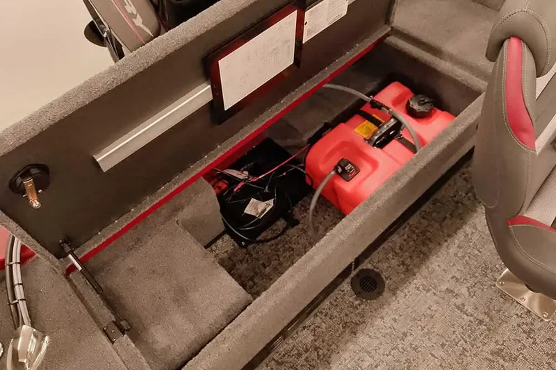 Slide: The Image of 2026 Ranger Aluminum VS1665 SC boat interior with storage compartment and red fuel tank. - 25
