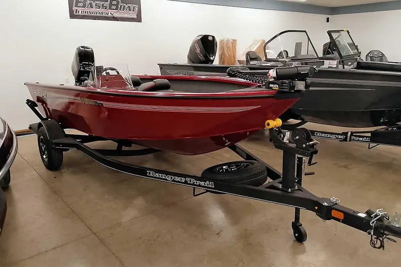 Slide: The Image of 2026 Ranger Aluminum VS1665 SC boat in showroom, red hull, on trailer. - 29