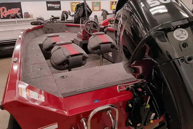 Slide: The Image of 2026 Ranger Aluminum VS1665 SC boat with Mercury engine, red interior, and dual seats. - 3