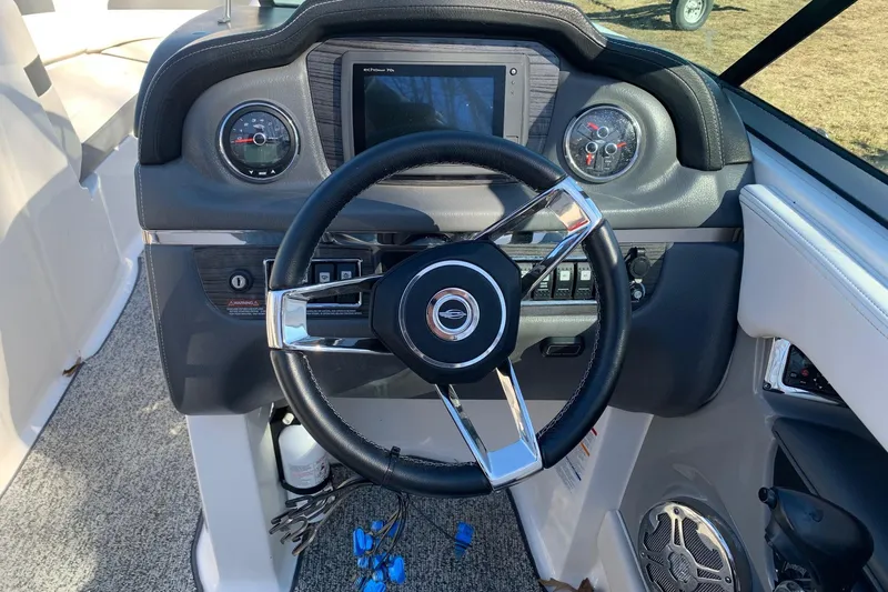 Slide: The Image of Steering wheel and dashboard of 2015 Chaparral 246 SSi boat. - 4