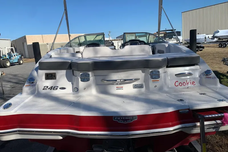 Slide: The Image of 2015 Chaparral 246 SSi boat with white and red exterior, docked outdoors. - 5