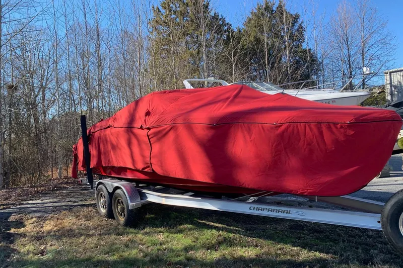 Slide: The Image of 2015 Chaparral 246 SSi boat covered in red tarp on trailer. - 8