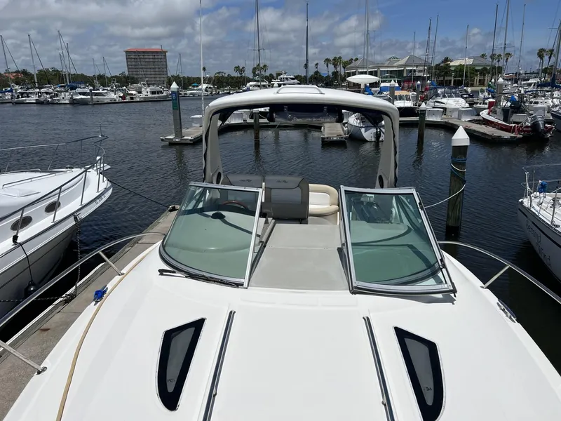 Slide: The Image of 2012 Sea Ray Sundancer yacht docked at marina with open deck and clear skies. - 10