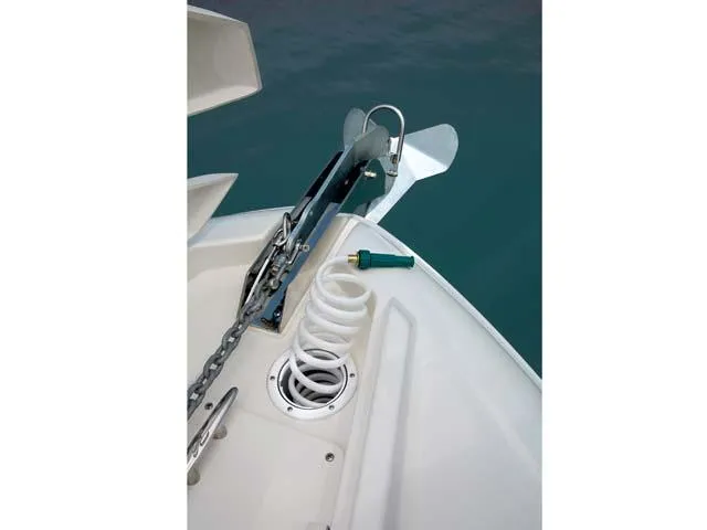 Slide: The Image of 2012 Sea Ray Sundancer anchor system on deck, featuring chain and coiled hose. - 13