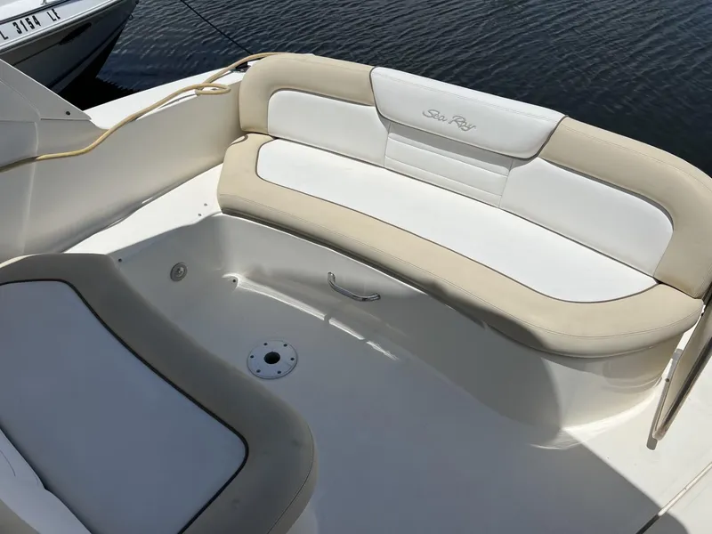 Slide: The Image of 2012 Sea Ray Sundancer boat seating area with beige and white cushions. - 19