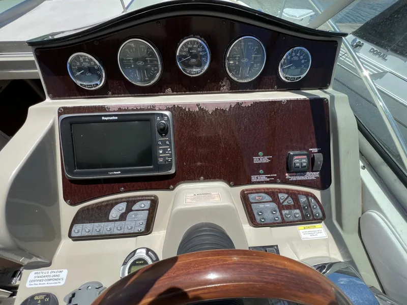 Slide: The Image of Dashboard of a 2012 Sea Ray Sundancer boat with navigation controls and gauges. - 24