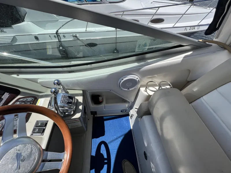 Slide: The Image of Interior view of 2012 Sea Ray Sundancer boat cockpit with steering wheel and controls. - 28