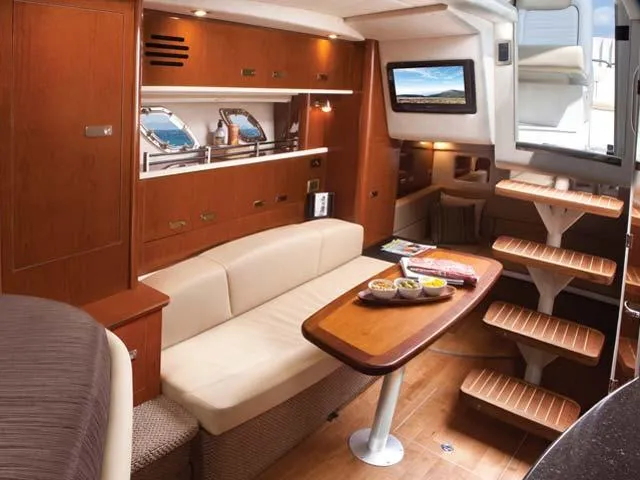 Slide: The Image of Luxurious 2012 Sea Ray Sundancer yacht interior with elegant wood finishes and cozy seating area. - 30