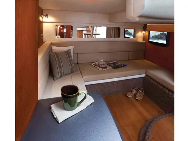 Slide: The Image of Interior of 2012 Sea Ray Sundancer yacht with cozy seating and wooden flooring. - 32