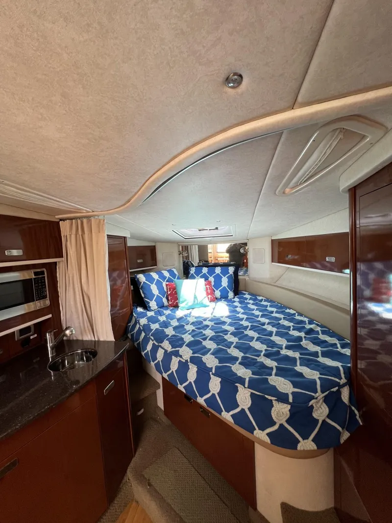 Slide: The Image of Interior of 2012 Sea Ray Sundancer with cozy bed and kitchenette. - 36