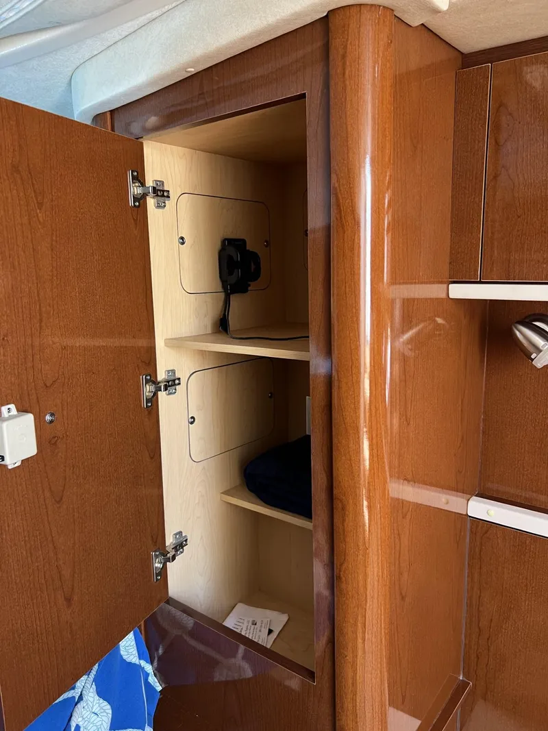 Slide: The Image of 2012 Sea Ray Sundancer interior cabinet with shelves and wood finish. - 39