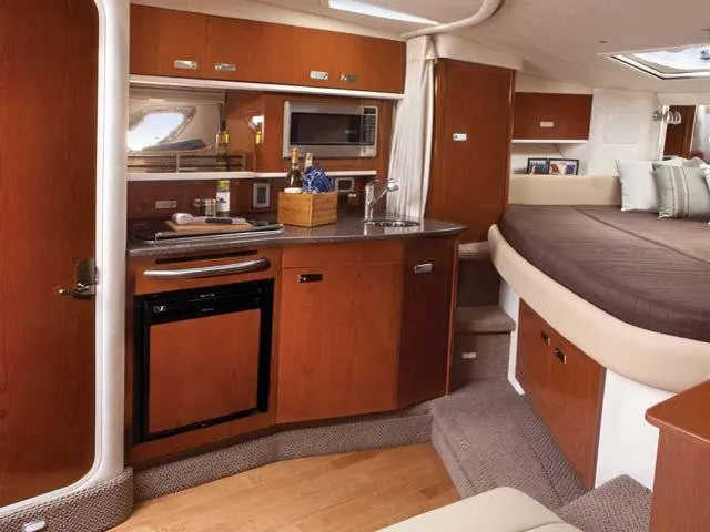 Slide: The Image of Luxurious 2012 Sea Ray Sundancer interior with kitchenette and cozy sleeping area. - 41