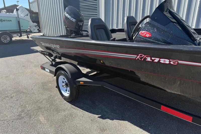 Slide: The Image of 2015 Ranger RT178C boat with Evinrude motor on trailer, parked outdoors. - 1