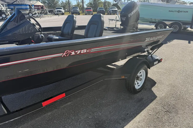 Slide: The Image of 2015 Ranger RT178C boat on trailer, featuring Evinrude motor, parked outdoors. - 2