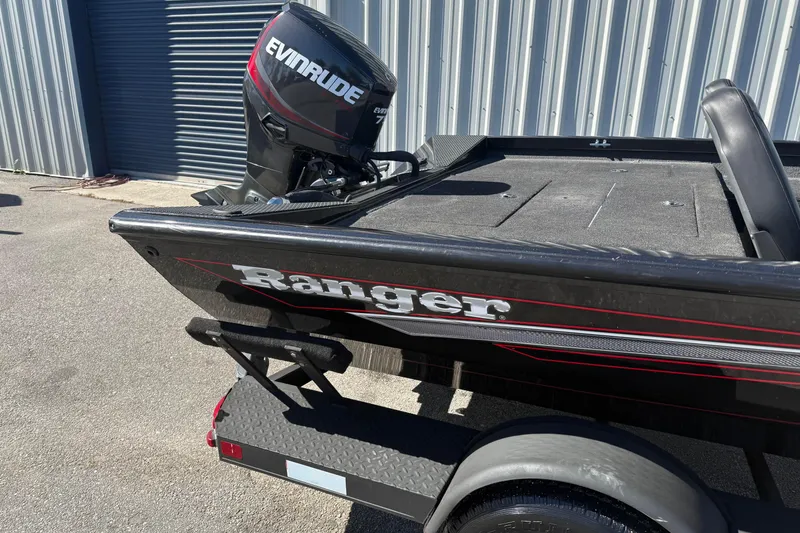 Slide: The Image of 2015 Ranger RT178C boat with Evinrude motor, parked near metal building. - 3