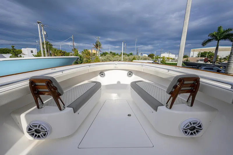 Slide: The Image of 2025 Valhalla Boatworks V-41 interior with seating and speakers under cloudy sky. - 15