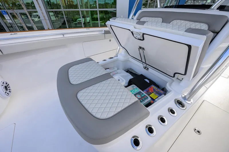Slide: The Image of 2025 Valhalla Boatworks V-41 storage compartment with cushioned seating and organized gear. - 22