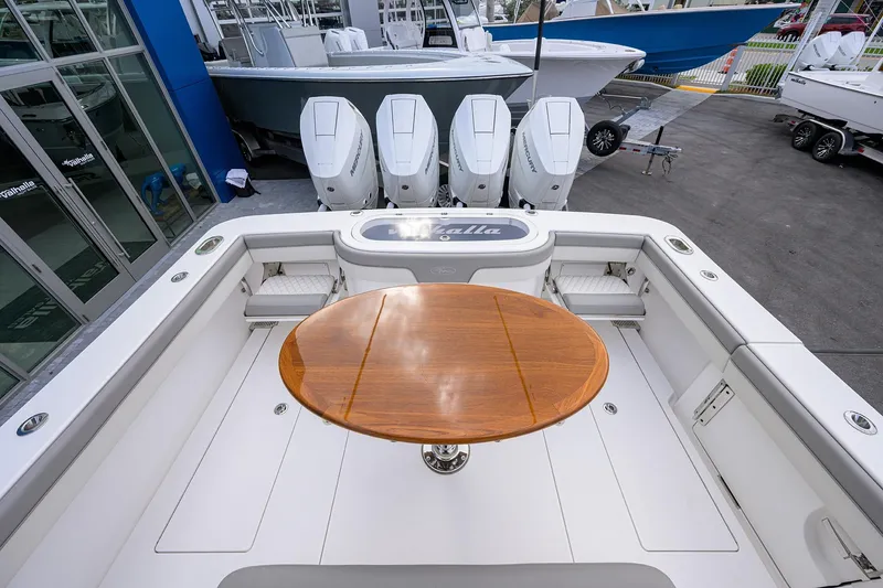 Slide: The Image of 2025 Valhalla Boatworks V-41 with wooden table and powerful outboard engines. - 28
