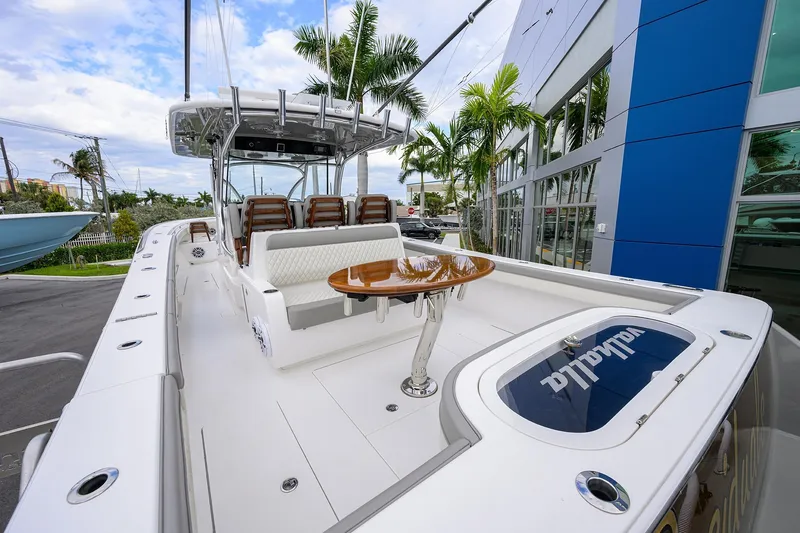 Slide: The Image of 2025 Valhalla Boatworks V-41, sleek design, luxurious seating, docked near palm trees. - 31