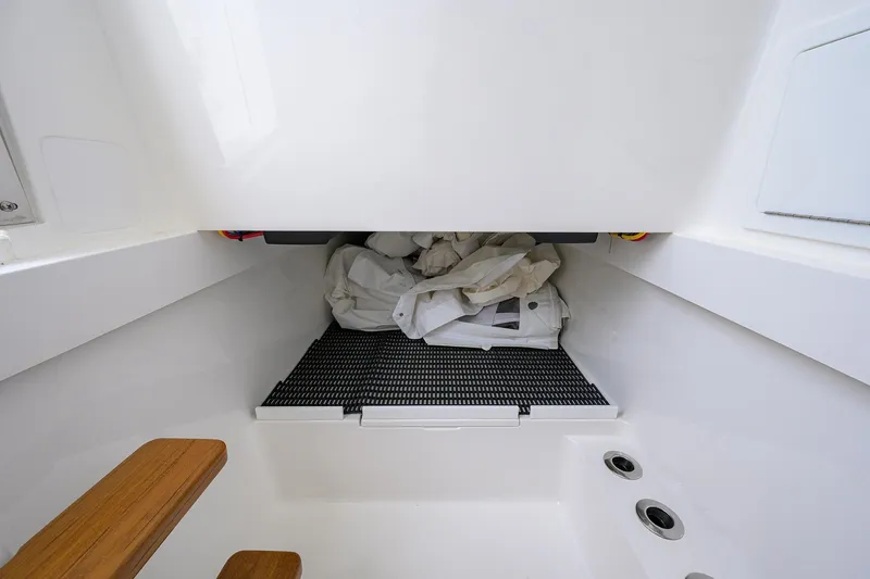 Slide: The Image of 2025 Valhalla Boatworks V-41 interior storage compartment with wooden steps and drainage holes. - 41