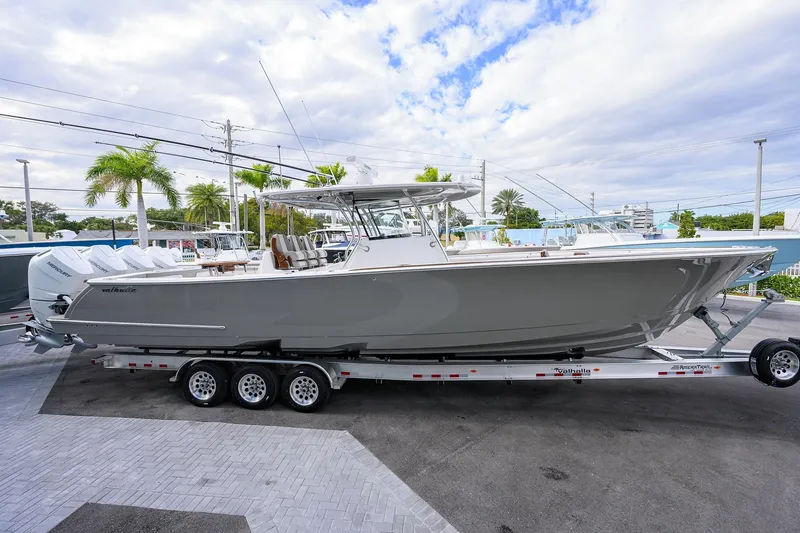 Slide: The Image of 2025 Valhalla Boatworks V-41 on trailer, sleek design, parked outdoors under cloudy sky. - 5