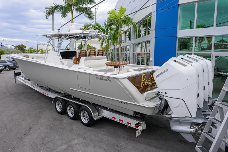 Slide: The Image of 2025 Valhalla Boatworks V-41 with quad Mercury engines on a trailer, parked outdoors. - 6