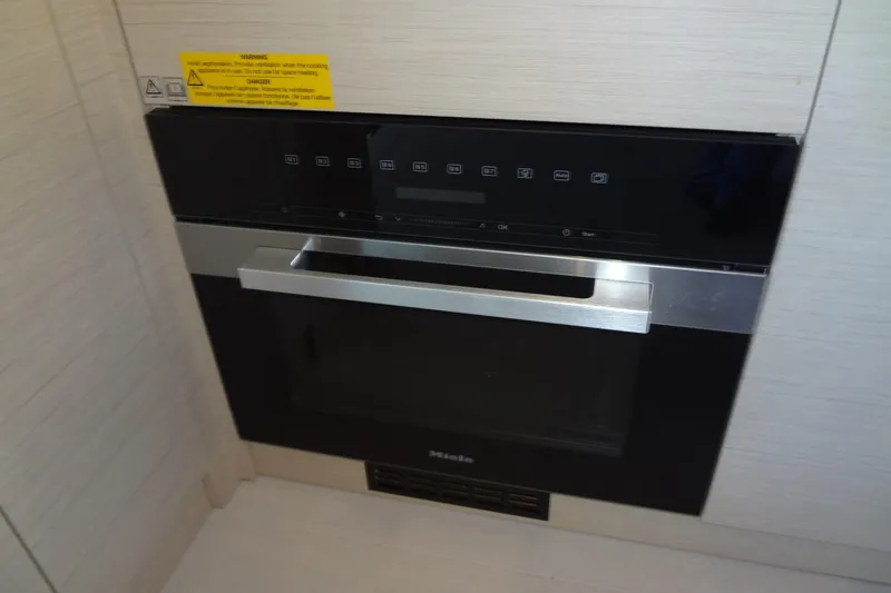 Slide: The Image of Modern kitchen and seating area in 2023 Prestige 420S yacht interior. - 25