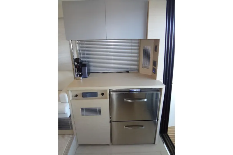 Slide: The Image of Modern kitchen area in 2023 Prestige 420S yacht with sleek cabinetry and appliances. - 26